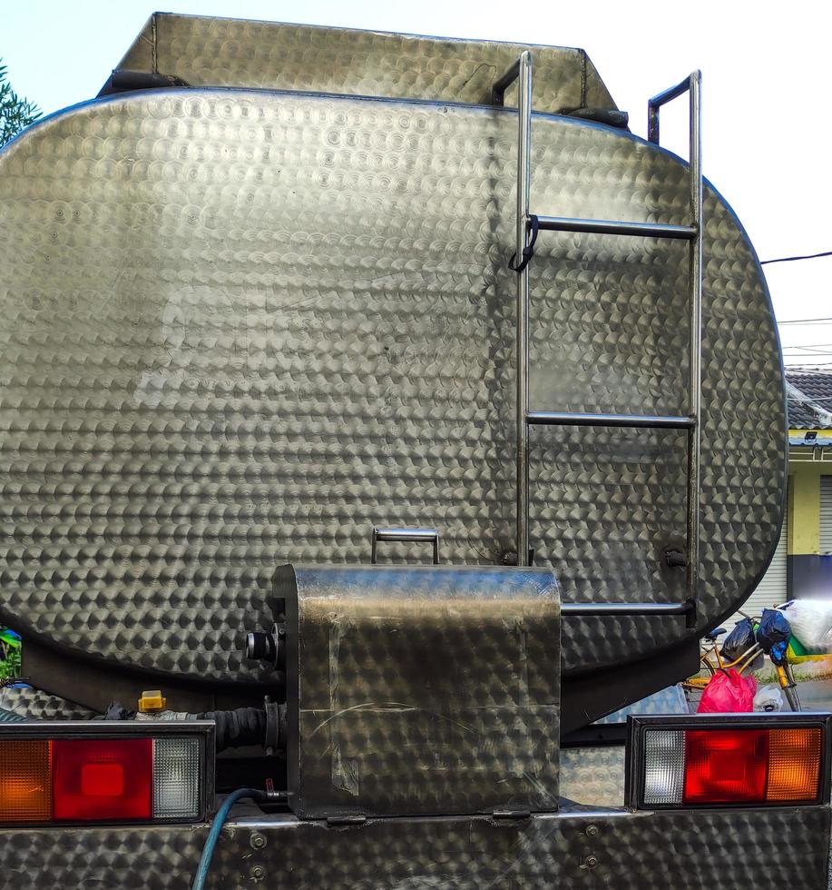 drinking water tanker truck stopped at the side of the road photo