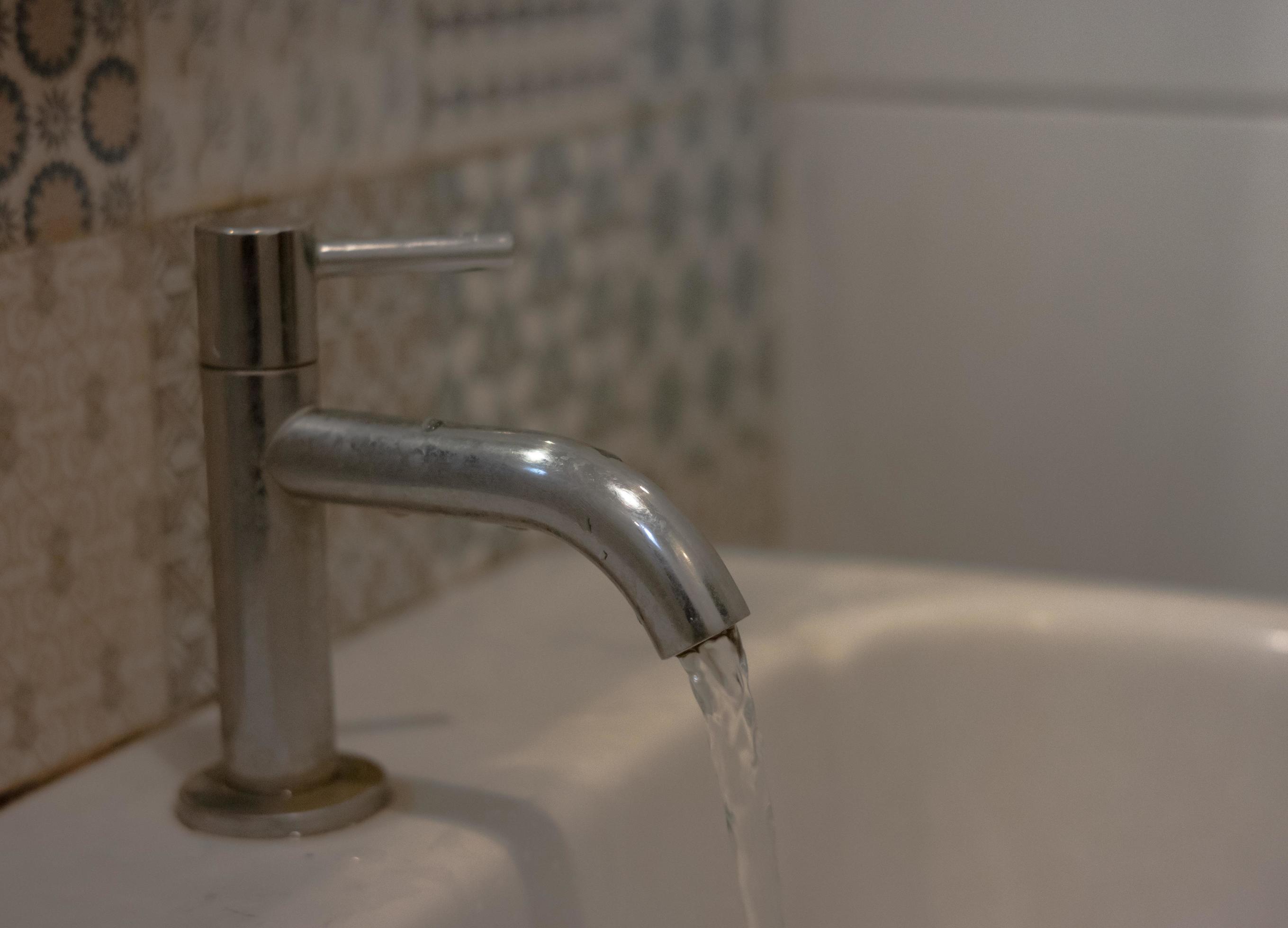 open the sink faucet in the bathroom 8177106 Stock Photo at Vecteezy