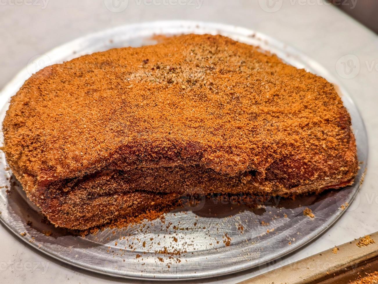 seasoning of beef brisket chunks of meat for smoking photo