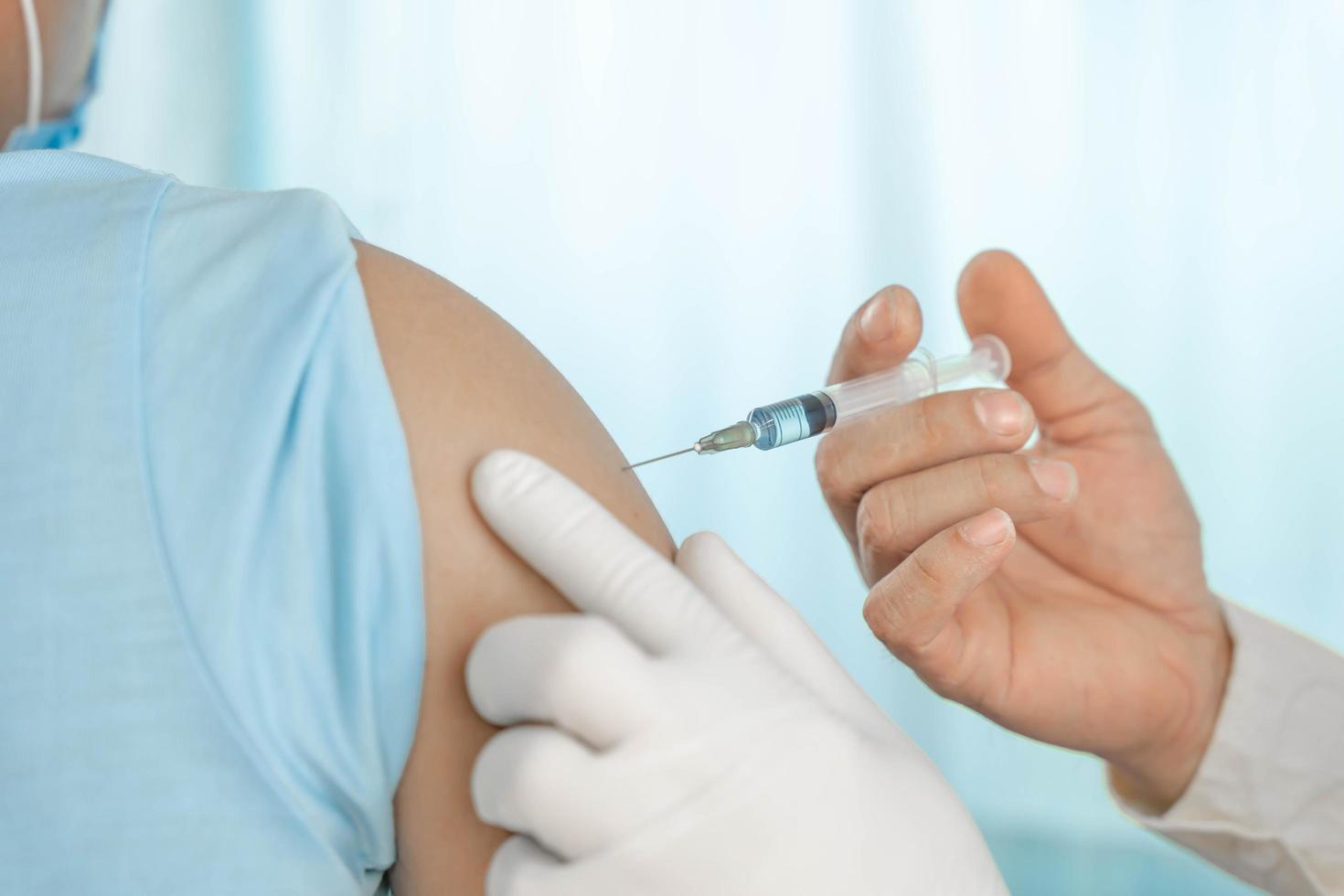 close up doctor holding syringe to injection to the patient in medical. Covid-19 or coronavirus vaccine. virus removal and prevention concept photo