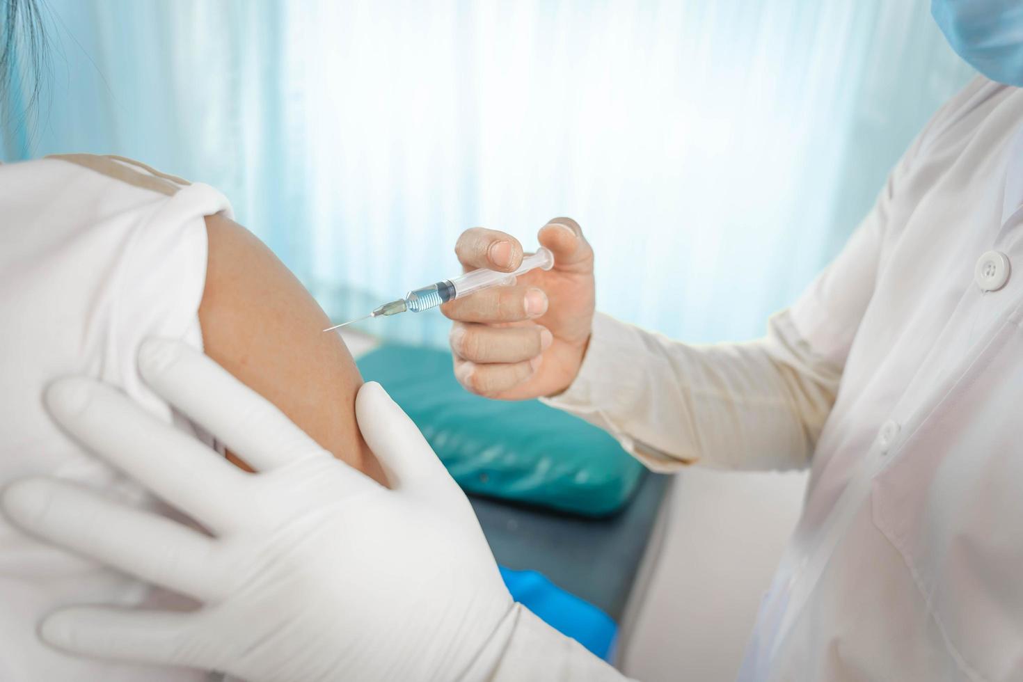 close up doctor holding syringe to injection to the patient in medical. Covid-19 or coronavirus vaccine. virus removal and prevention concept photo