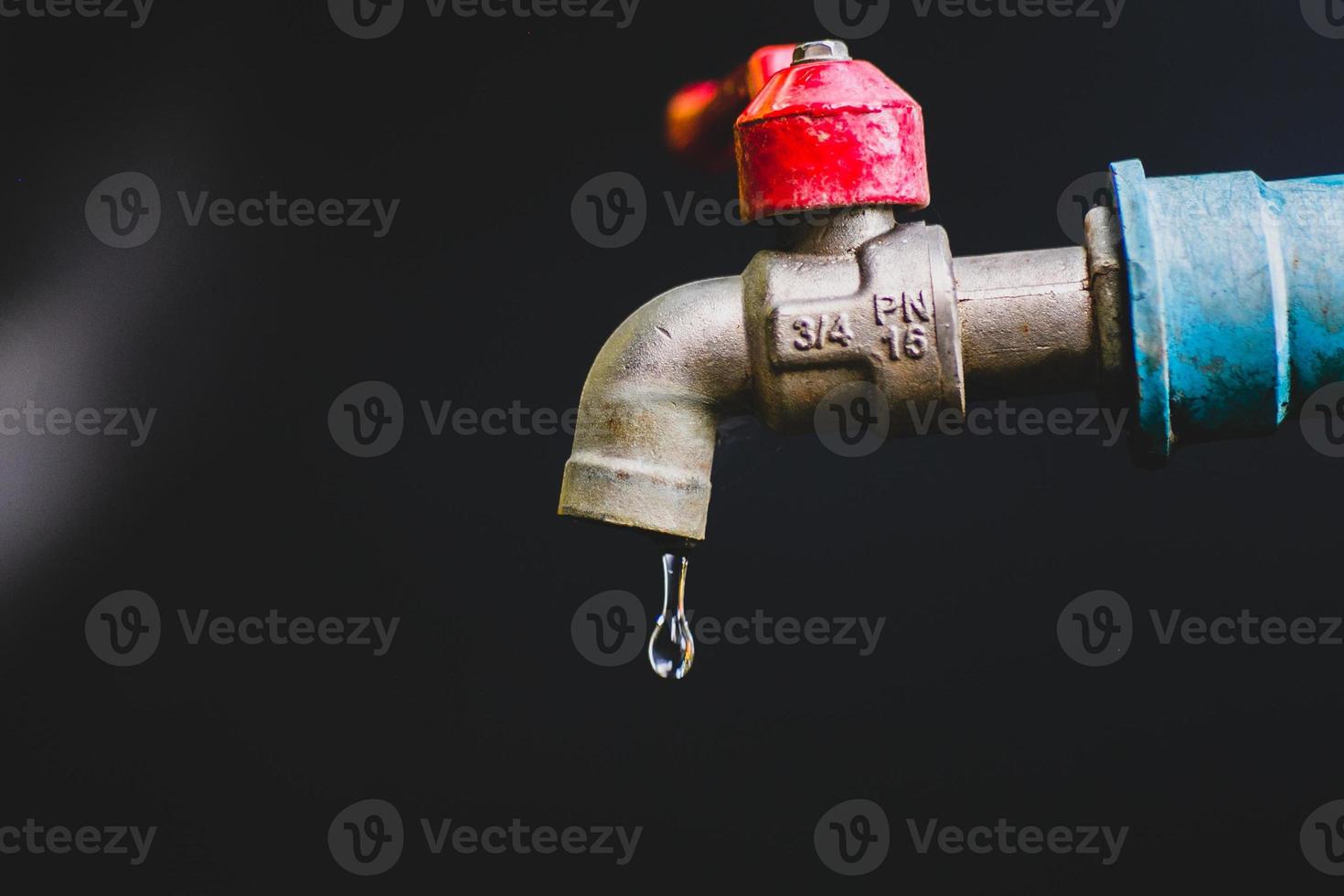 Crisis concept of fresh water shortage due to environmental changes. water tap without running water On a black background there is a copy space. photo