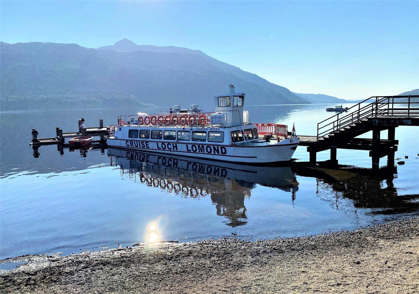 Loch Lomond in the UK in August 2021. A view of Loch Lomond in Scotland in the morning sunshine showing Tourist boats photo