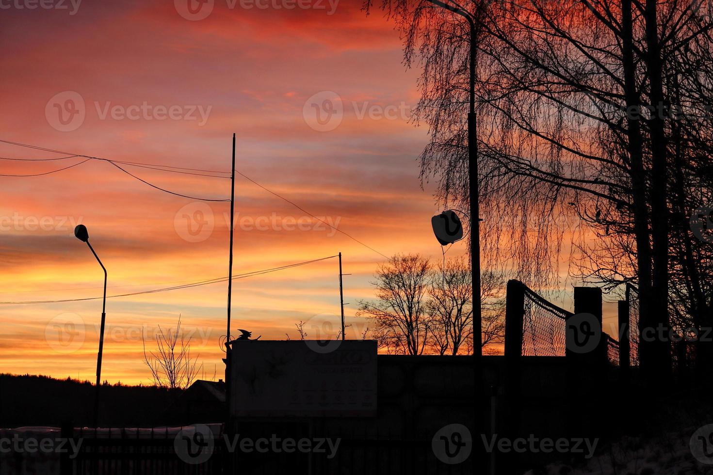 Industrial city part silhouettes on beautiful bright colors of sunset over city photo