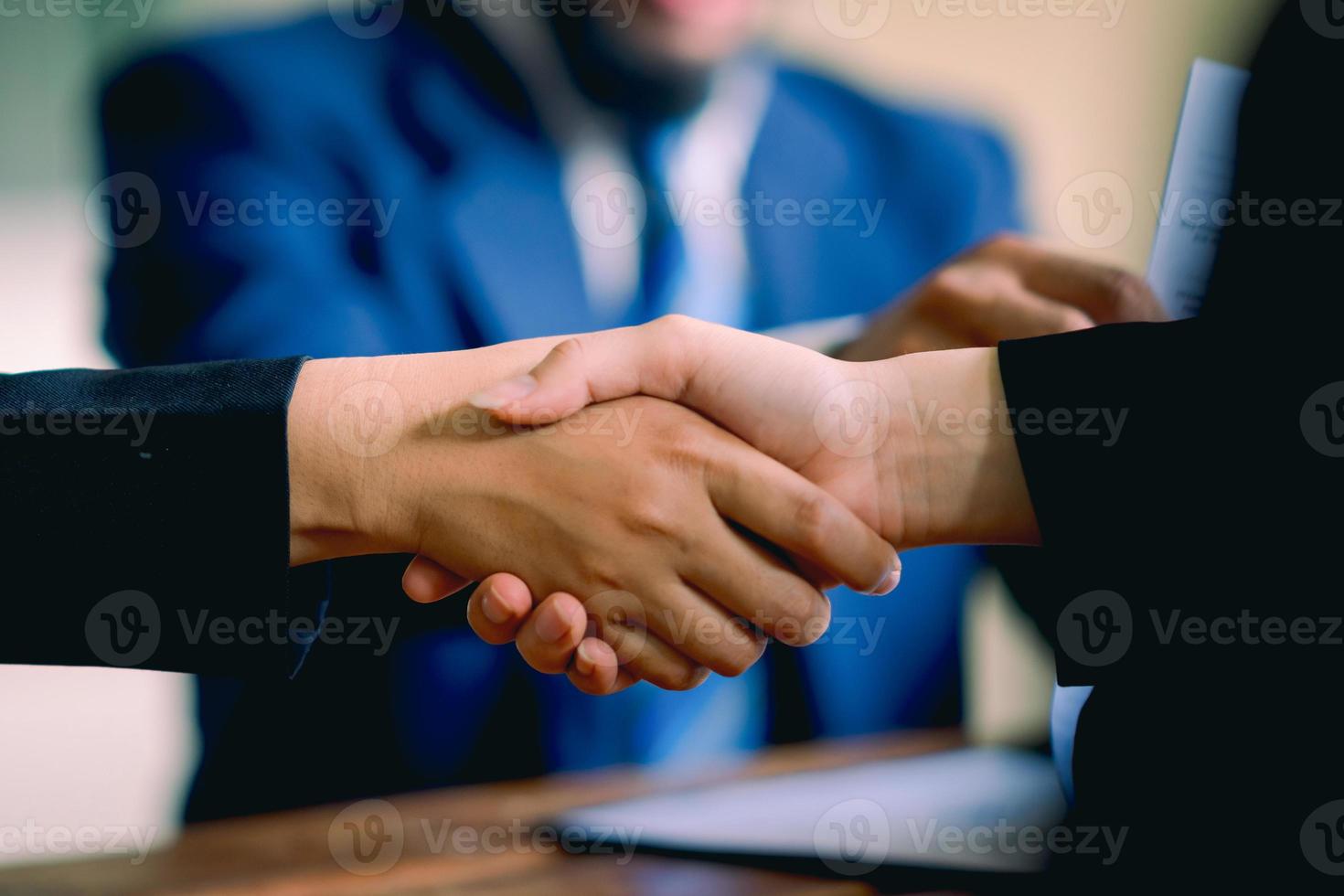 The hands of a group of businessmen shake hands to reach an agreement in a company meeting. photo