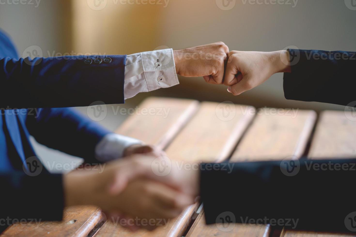 The hands of a group of businessmen shake hands to reach an agreement in a company meeting. photo