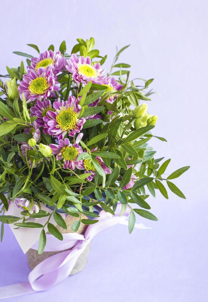 Floral composition in pot on pink pastel background. Beautiful bouquet of spring flowers. Valentine Day, Mothers day, birthday, spring concept photo