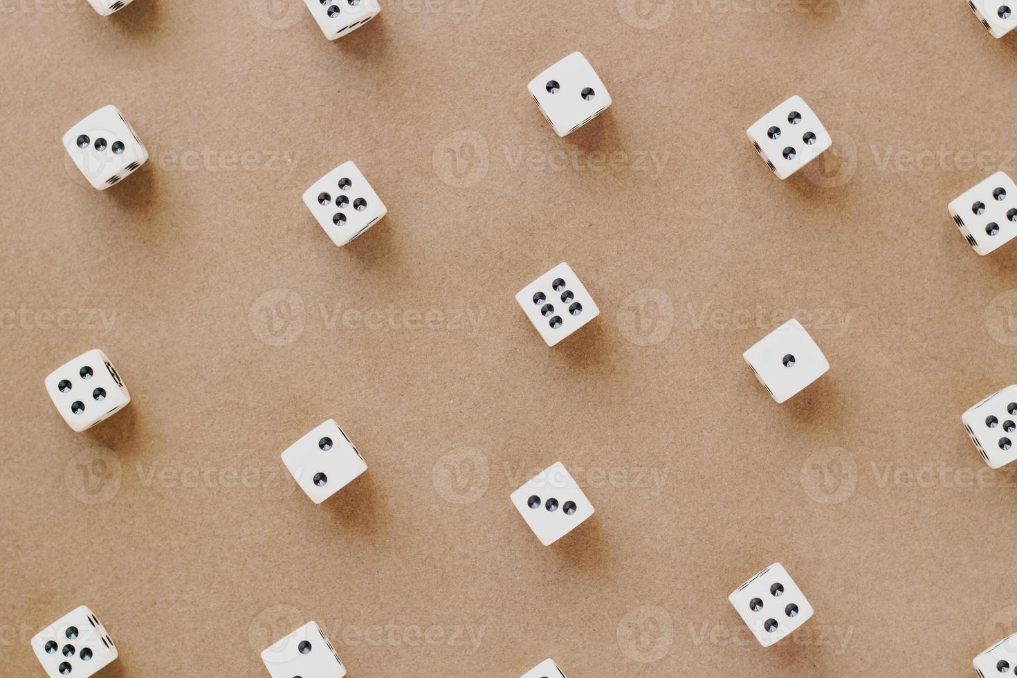 Gaming dice pattern on brown background in flat lay style. Concept with copy space for games, game board, role playing game, risk, chance, good luck or gambling. Toned image top view. Close-up photo