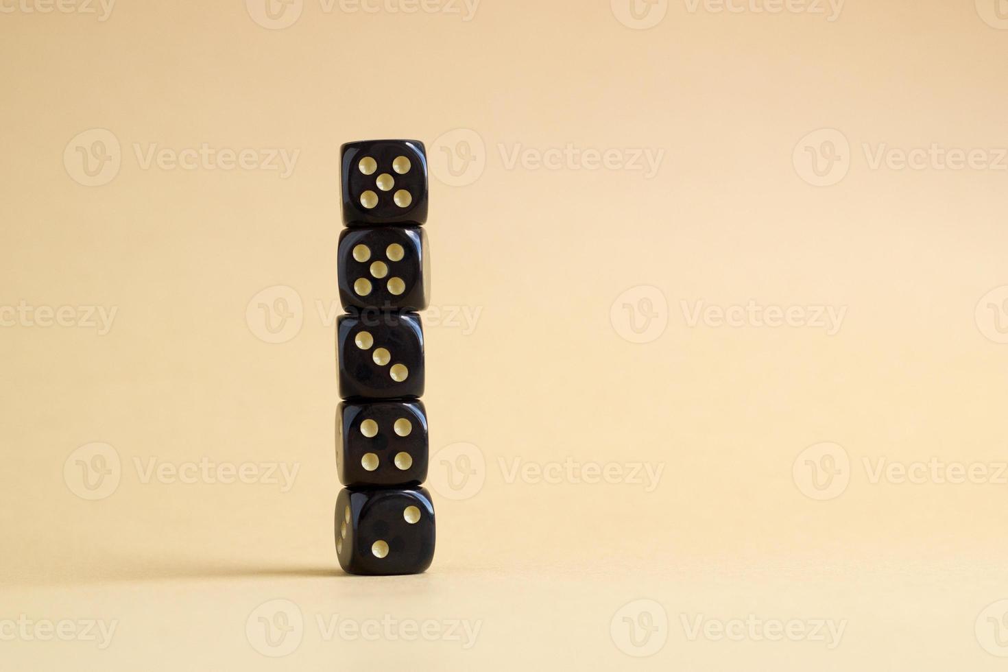 Stack of gaming dice with copy space on beige background. Concept for games, game board, role playing game, risk, chance, good luck or gambling. Image top view. photo