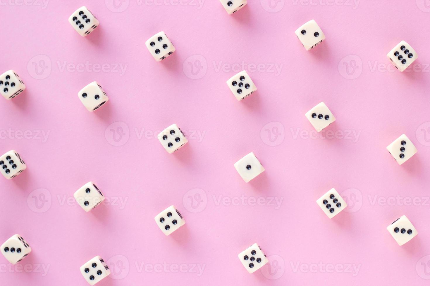 Gaming dice pattern on pink background in flat lay style. Concept for games, game board, presentation, banners or web. Top view. Close-up. photo