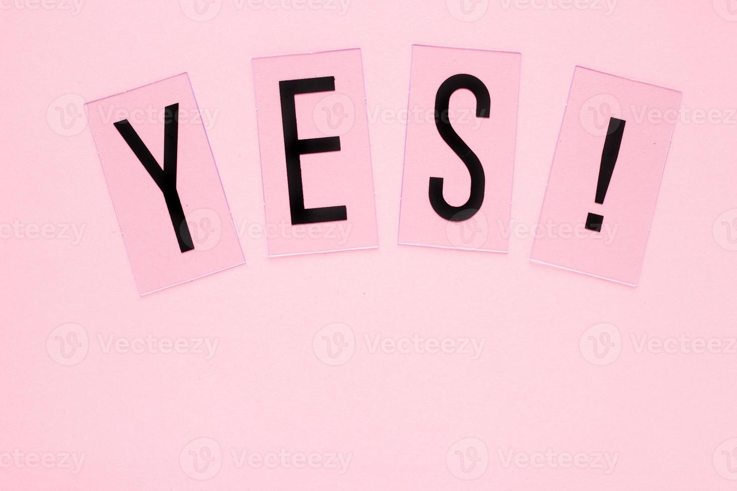 YES word plastic letters with copy space on pink background. Pastel concept for web, presentation, banners or motivation. Top view image photo