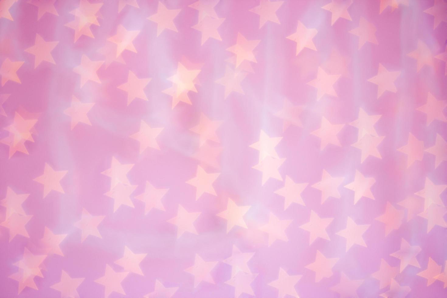 Abstract pink blurred background with shine lights stars. Texture with bokeh effect in de-focused. Decorations concept for design, display, holiday photo