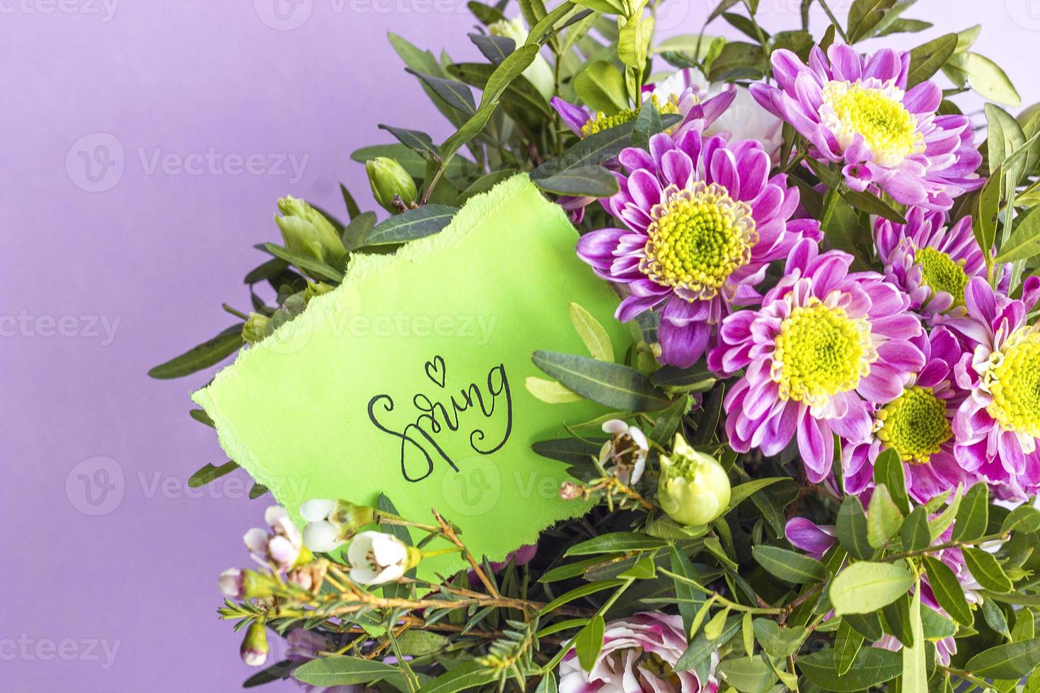 Floral composition with word SPRING on pink pastel background. Beautiful bouquet of spring flowers with copy space. Valentine Day, Mothers day, birthday, spring concept photo