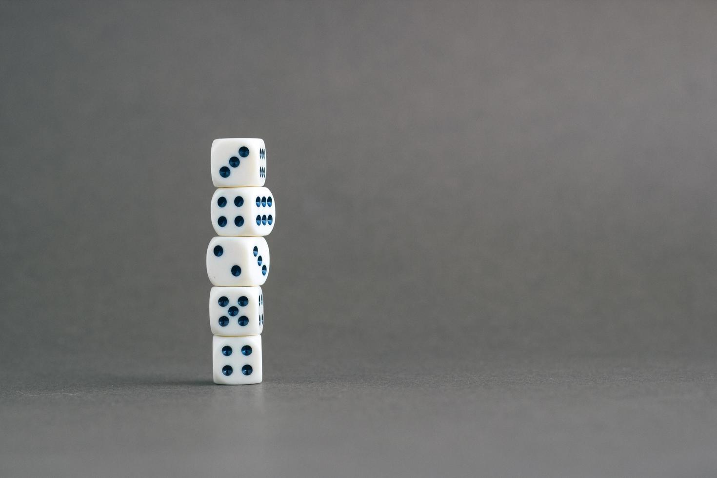 Stack of gaming dice with copy space on gray background. Concept for games, game board, role playing game, risk, chance, good luck or gambling. Image top view photo