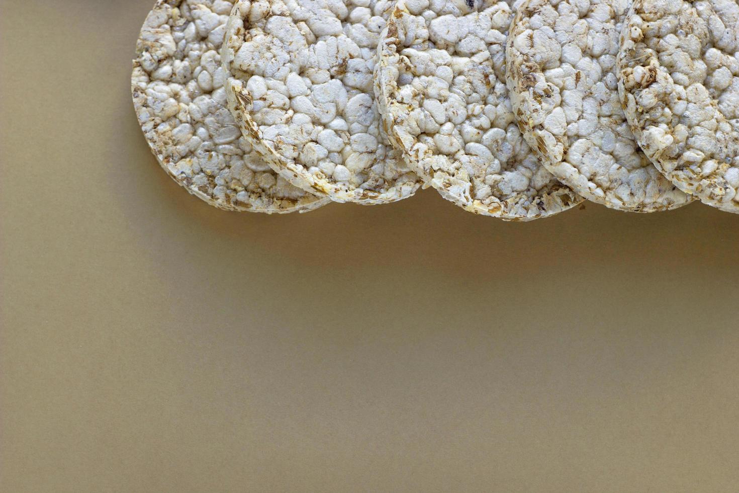 Crunchy round crispbreads on brown kraft paper background. Concept of healthy diet with copy space. Top view and flatlay. photo