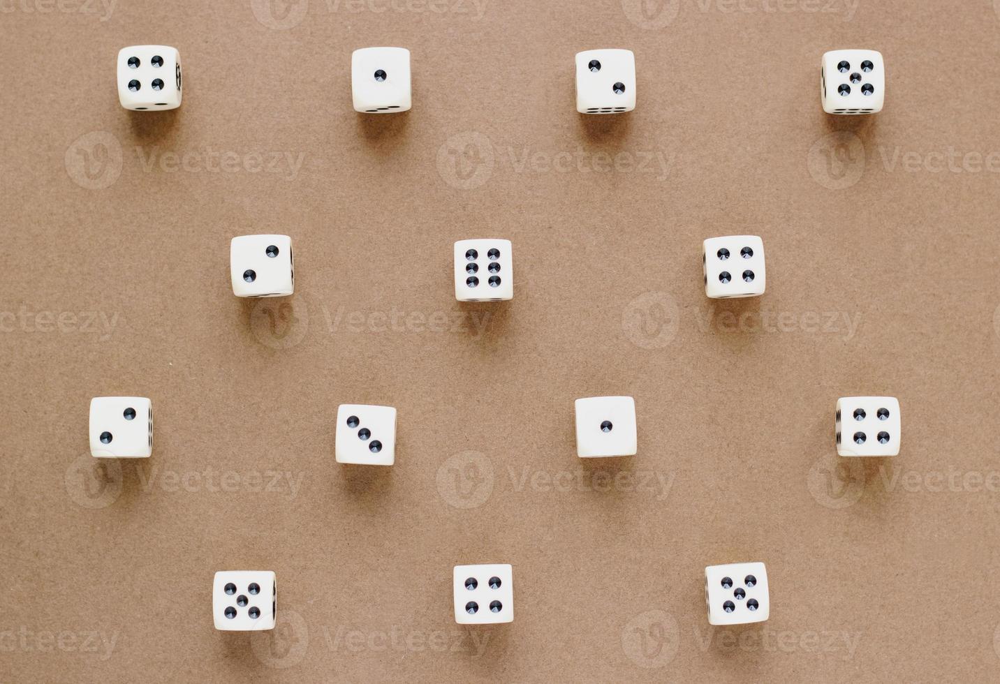 Gaming dice pattern on brown background in flat lay style. Concept with copy space for games, game board, role playing game, risk, chance, good luck or gambling. Toned image top view. Close-up photo