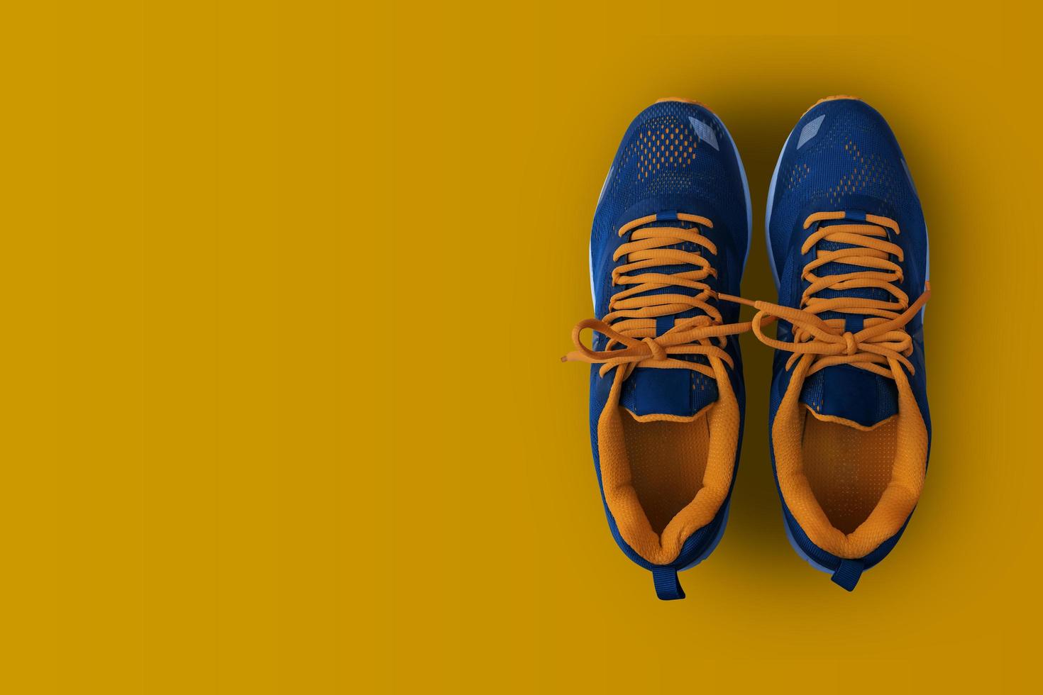 Sport shoes isolated on yellow background. photo