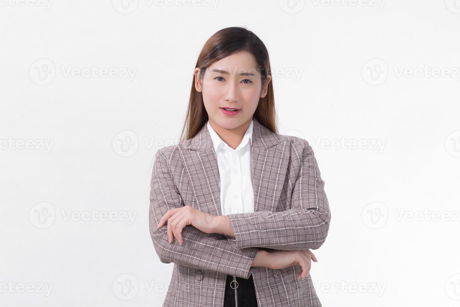 Asian confident woman in formal suit is standing and arm crossing with smiling face on white background. photo