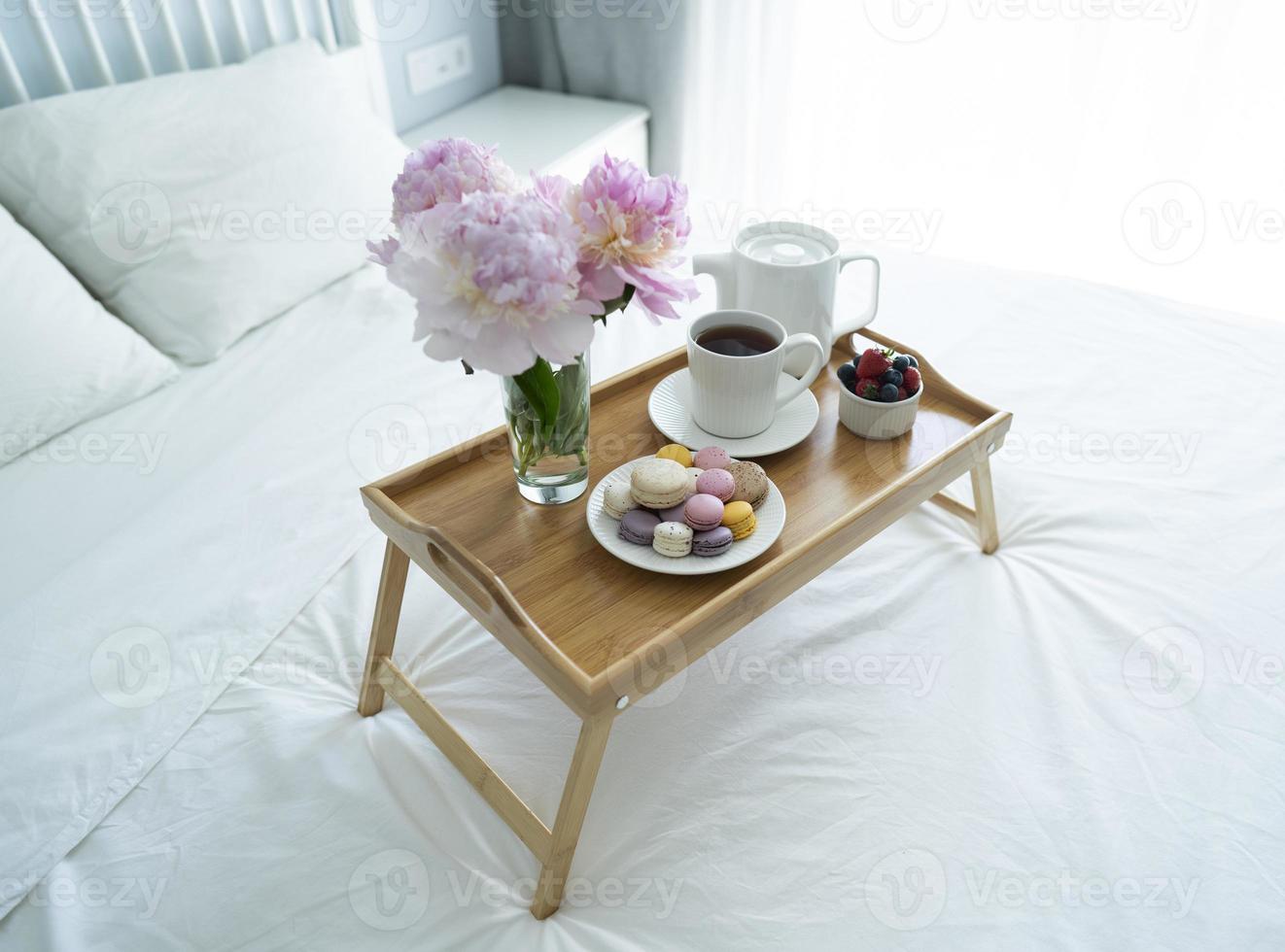 Tray with breakfast on bed. photo