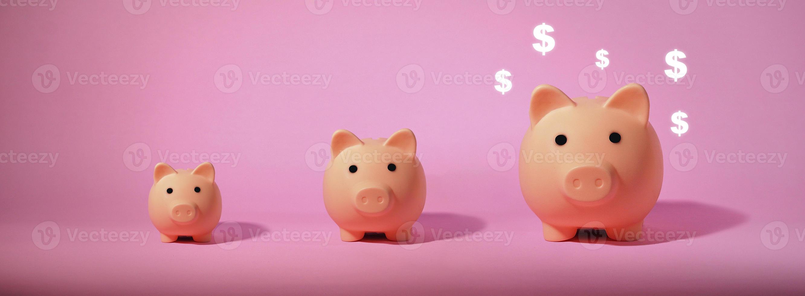 Piggy bank isolated on pink background. Saving money concept. photo