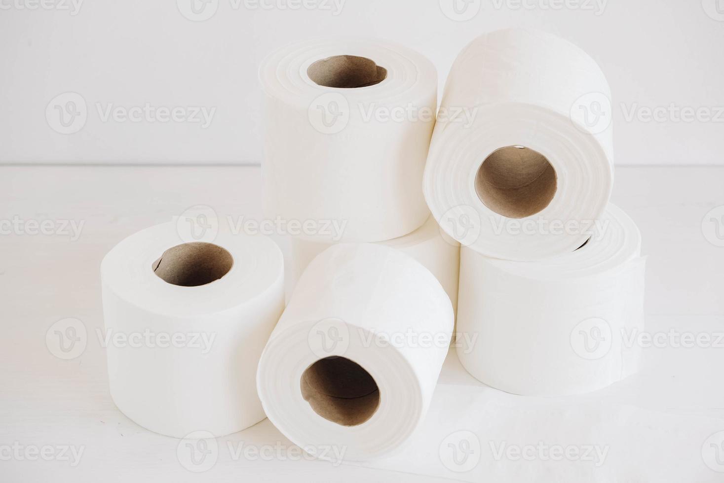 Rolls of white toilet paper on a white background photo