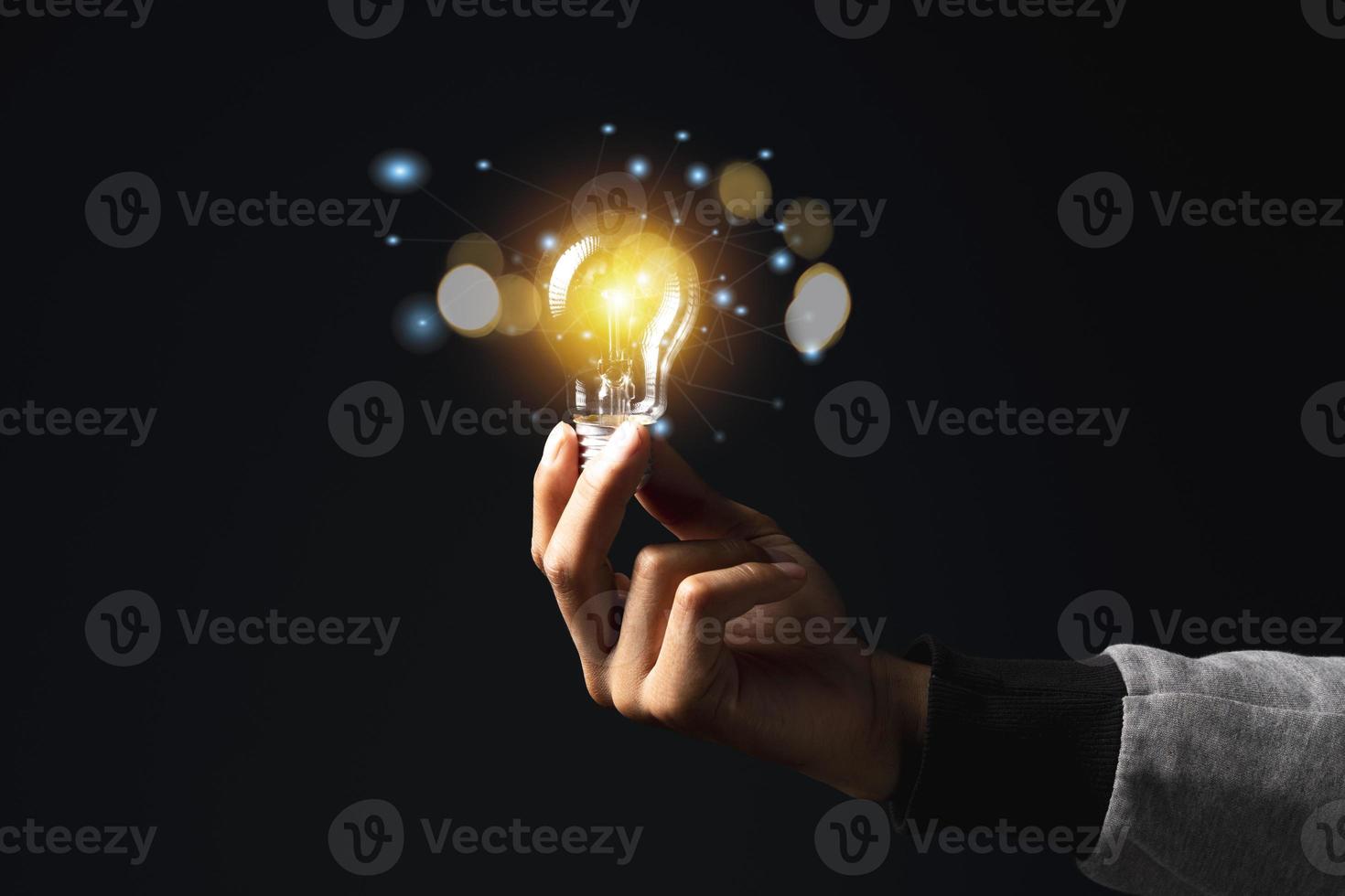 Hand of holding illuminated light bulb, idea, innovation inspiration concept photo