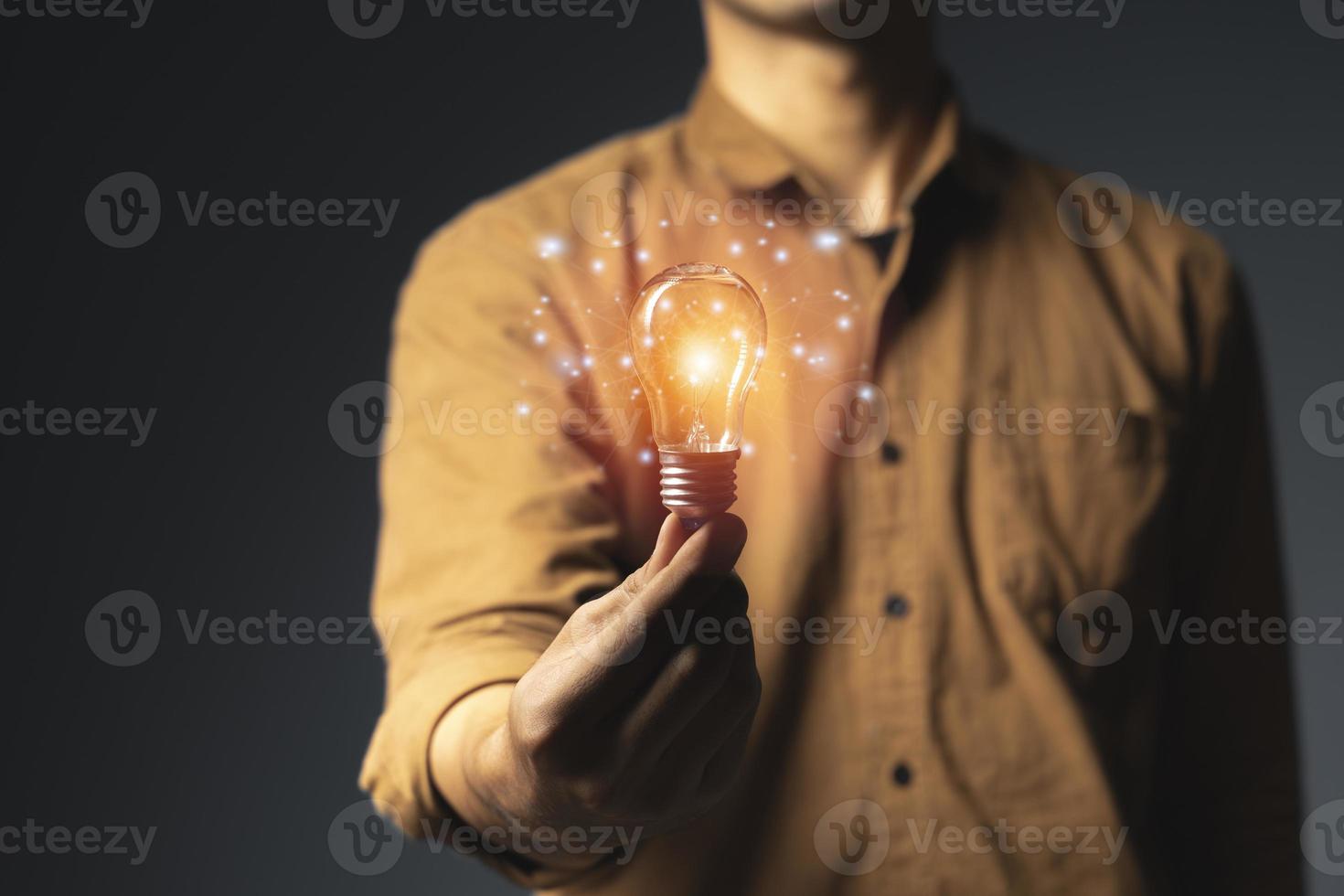 Man holding light bulbs, ideas of new ideas with innovative technology and creativity photo