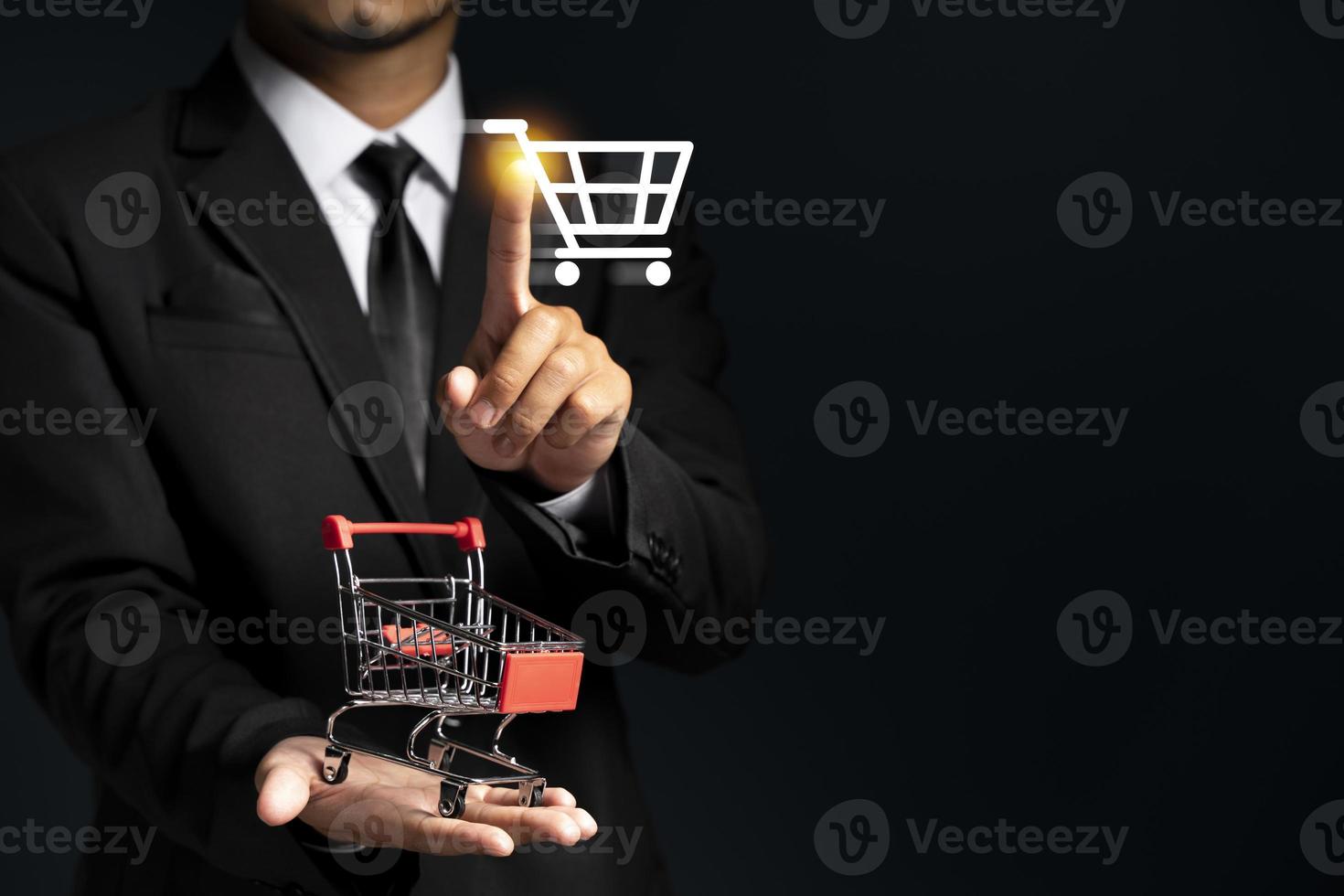 Close-up of business man hand holding trolley miniature. photo