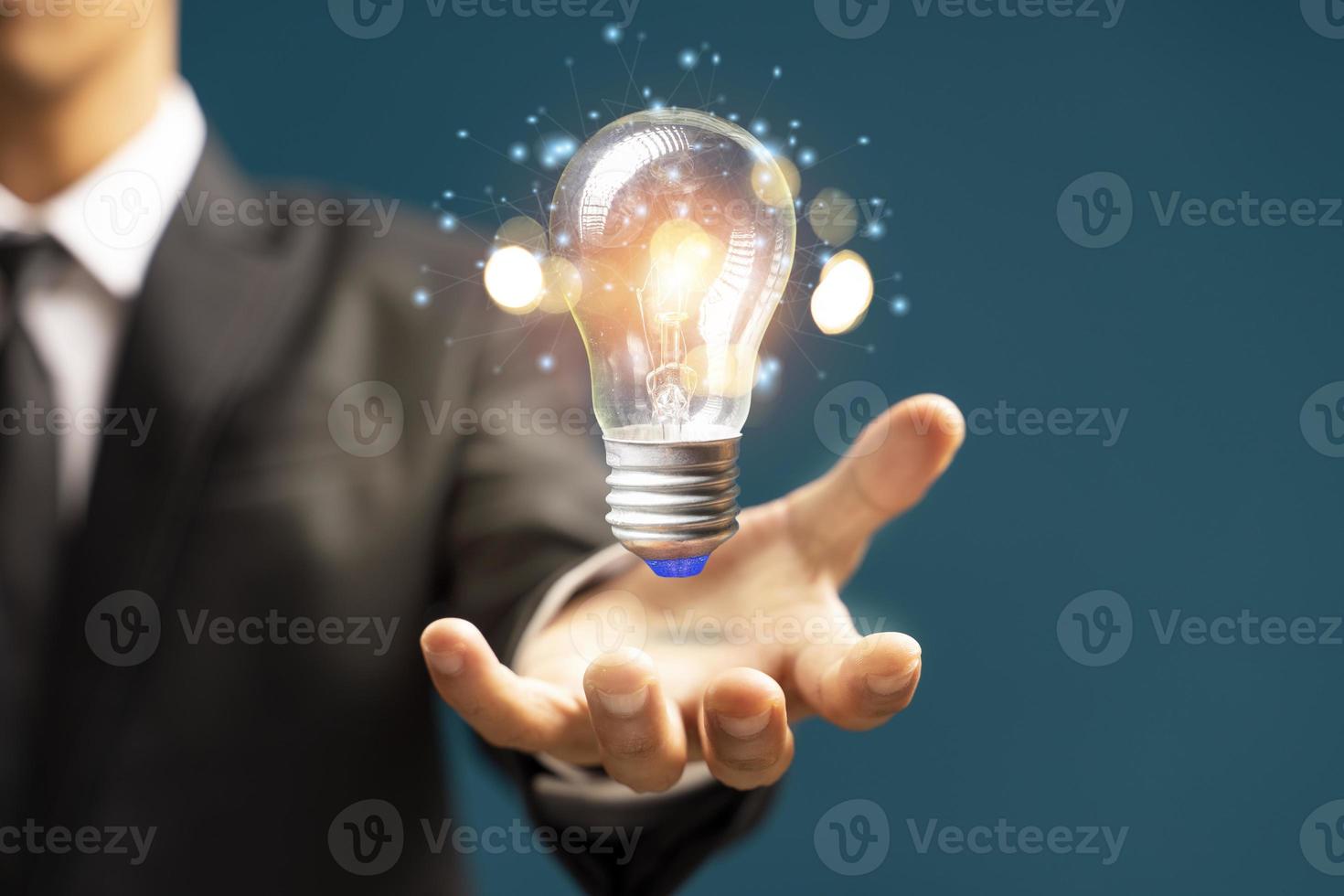 Man holding light bulbs, ideas of new ideas with innovative technology and creativity photo
