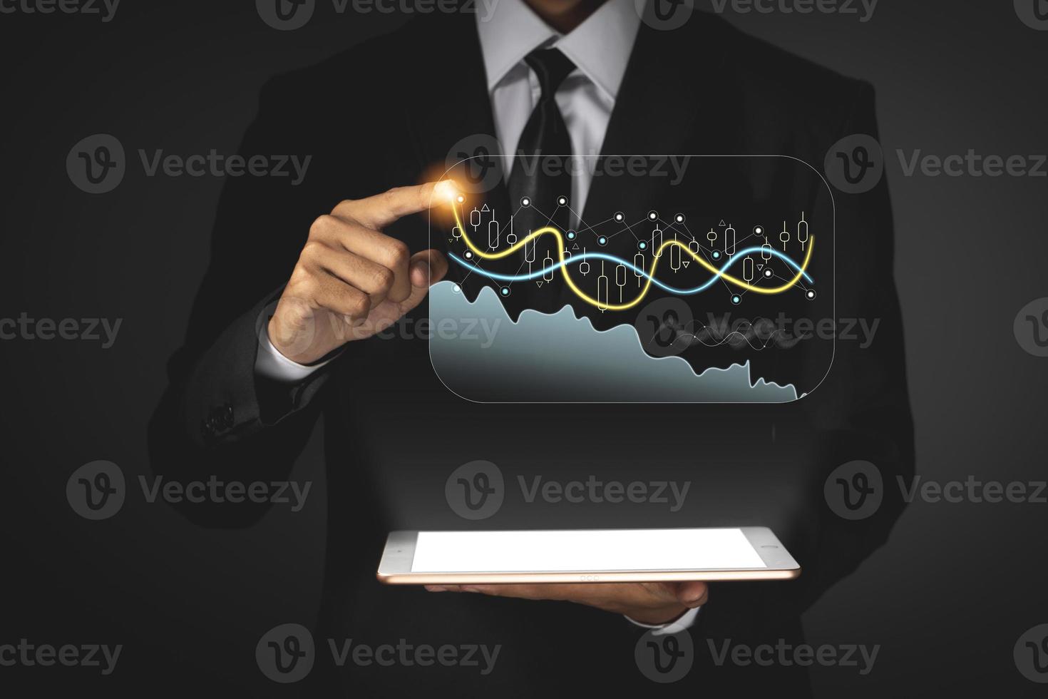 Business man holding tablet and showing holographic graphs and stock market statistics gain profits. photo