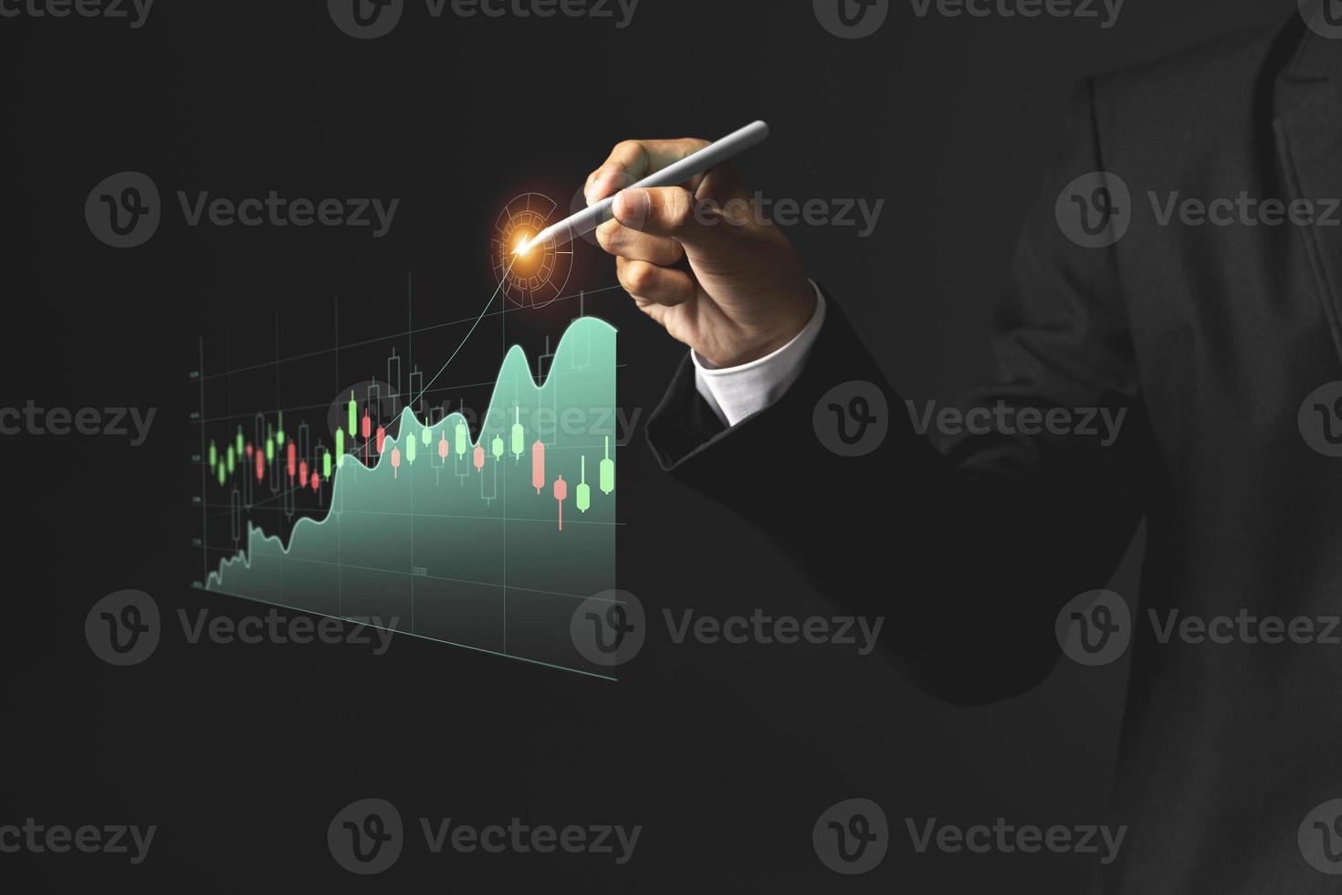 Business man holding pen and showing holographic graphs and stock market statistics gain profits. photo