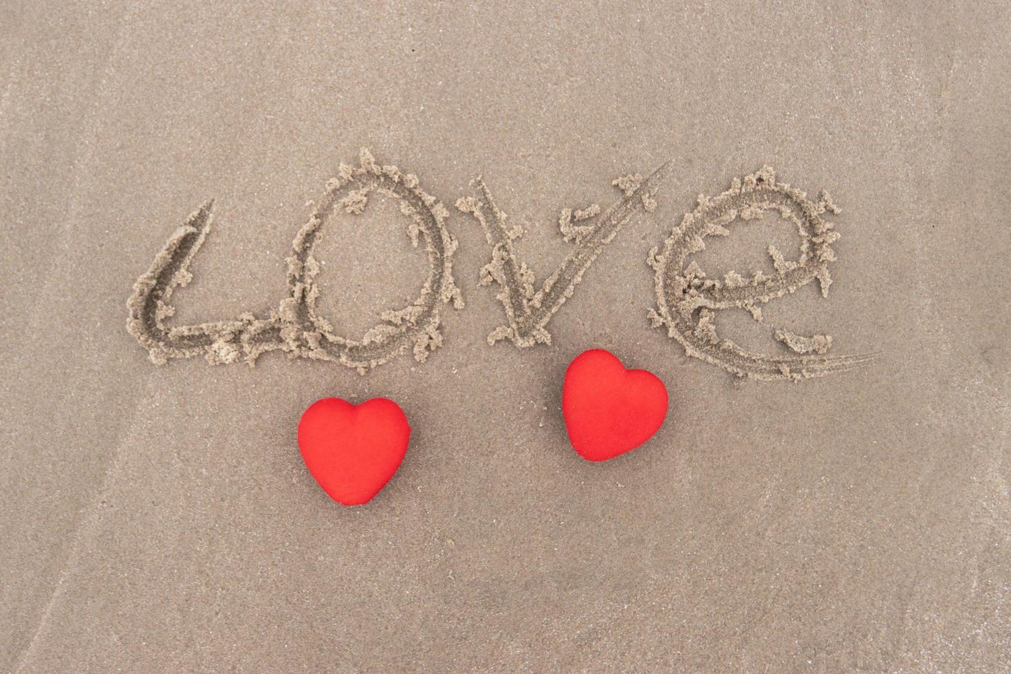 Top View Red heart on a sandy beach concept Valentine day photo