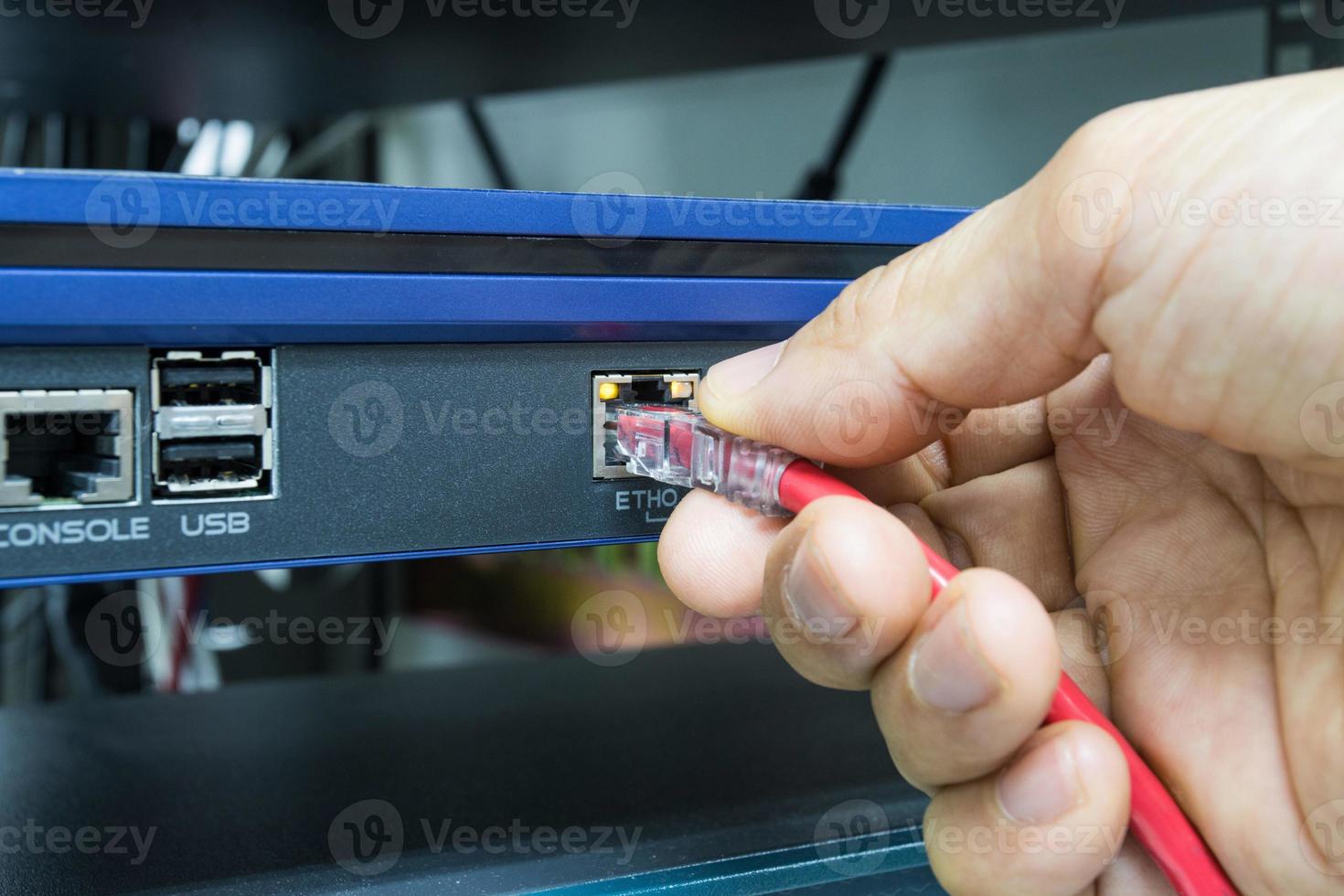 Hand of man holding The network cables to connect Lan port photo
