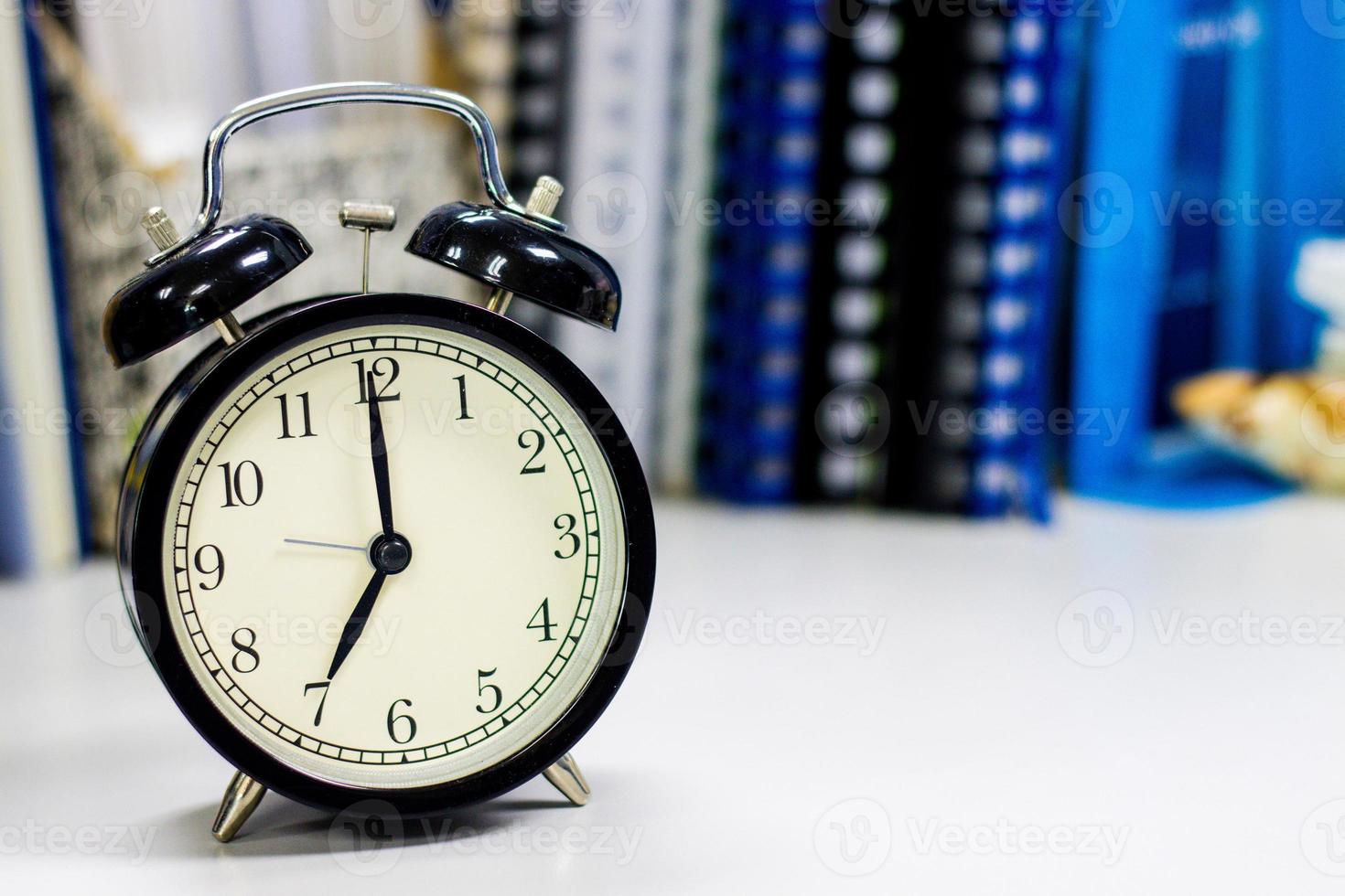 7 AM Clock on work desk in the office Time of businessman working concepts selective clock copy space photo