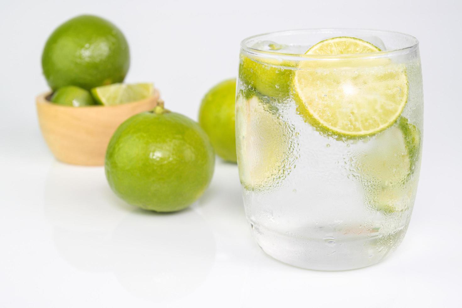 Juice Drink from Fresh Lemon cut into pieces in water glass photo