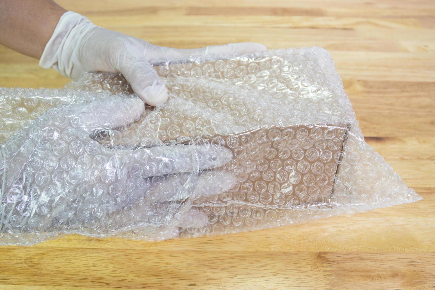 hand of man hold bubble wrap, for protection parcel product cracked or insurance During transit photo