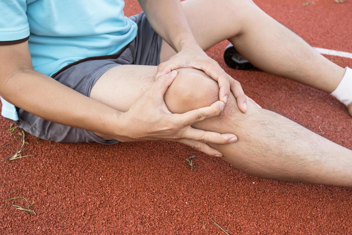 Tendon knee joint problems on Man leg from exercise In the stadium. photo
