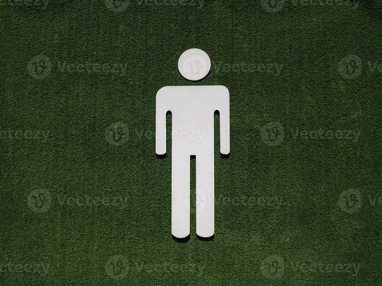 male symbol on fake green grass photo