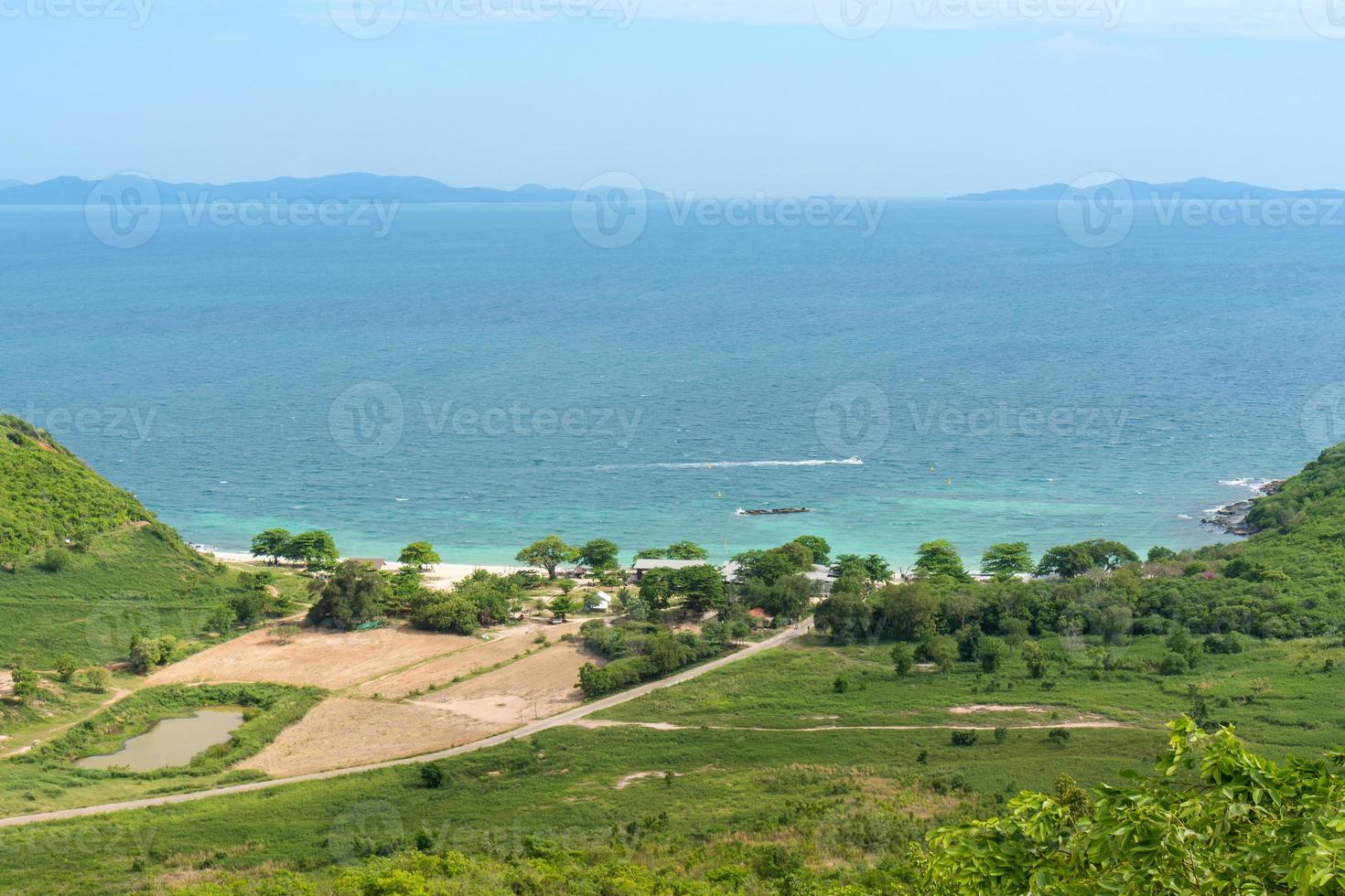 top view of blue sea beach on island, beautiful seascape with fresh green trees on land photo