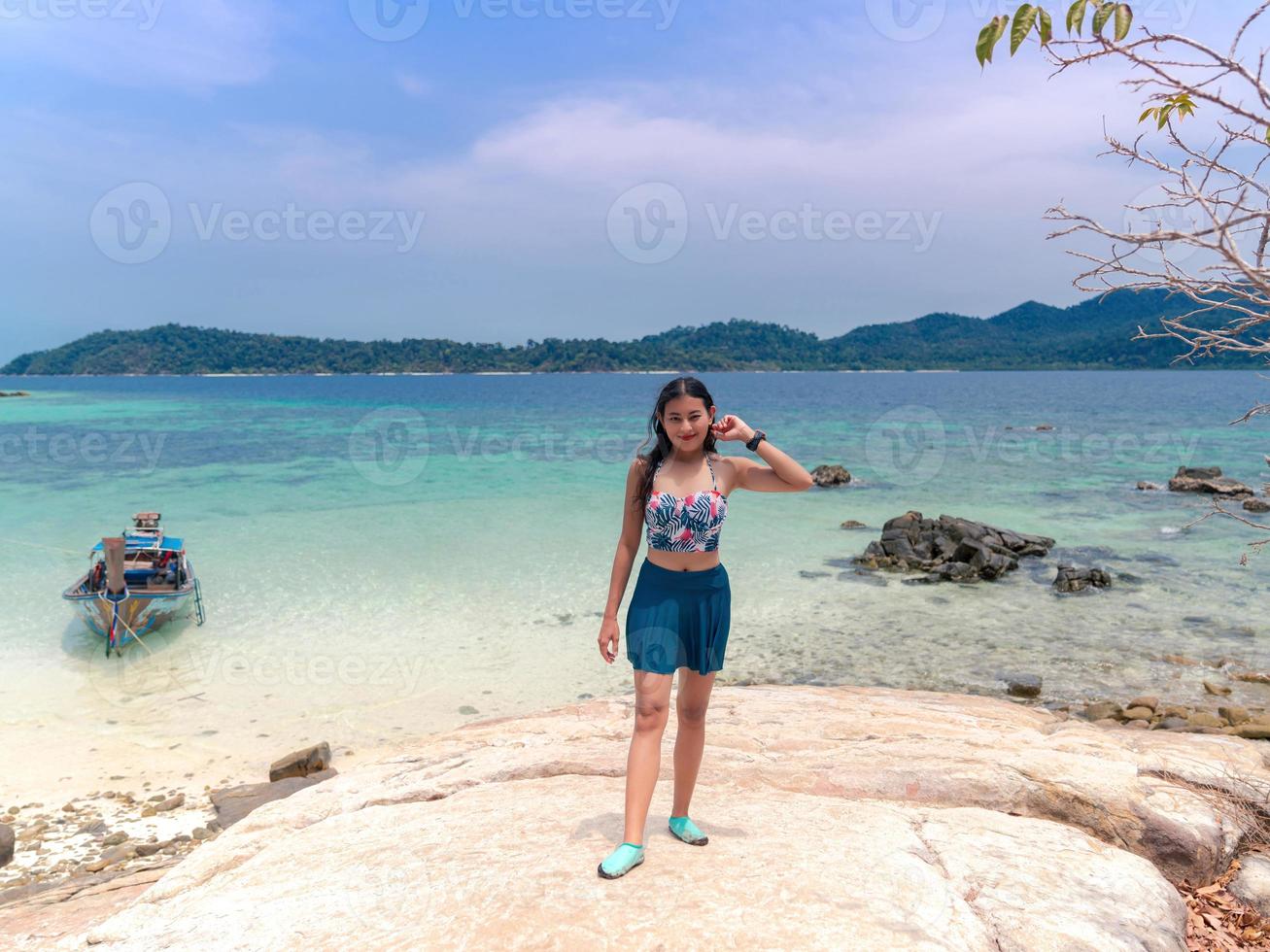 happy woman in swimsuit stand on rock viewpoint on Rockroy Island photo