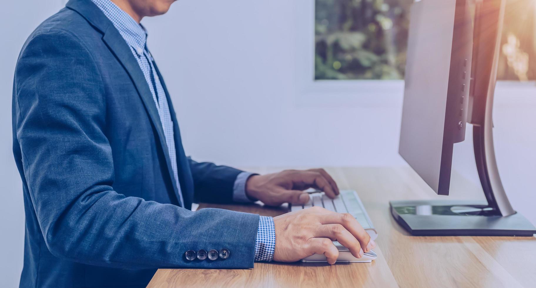 business people sitting in front of the computer screen photo