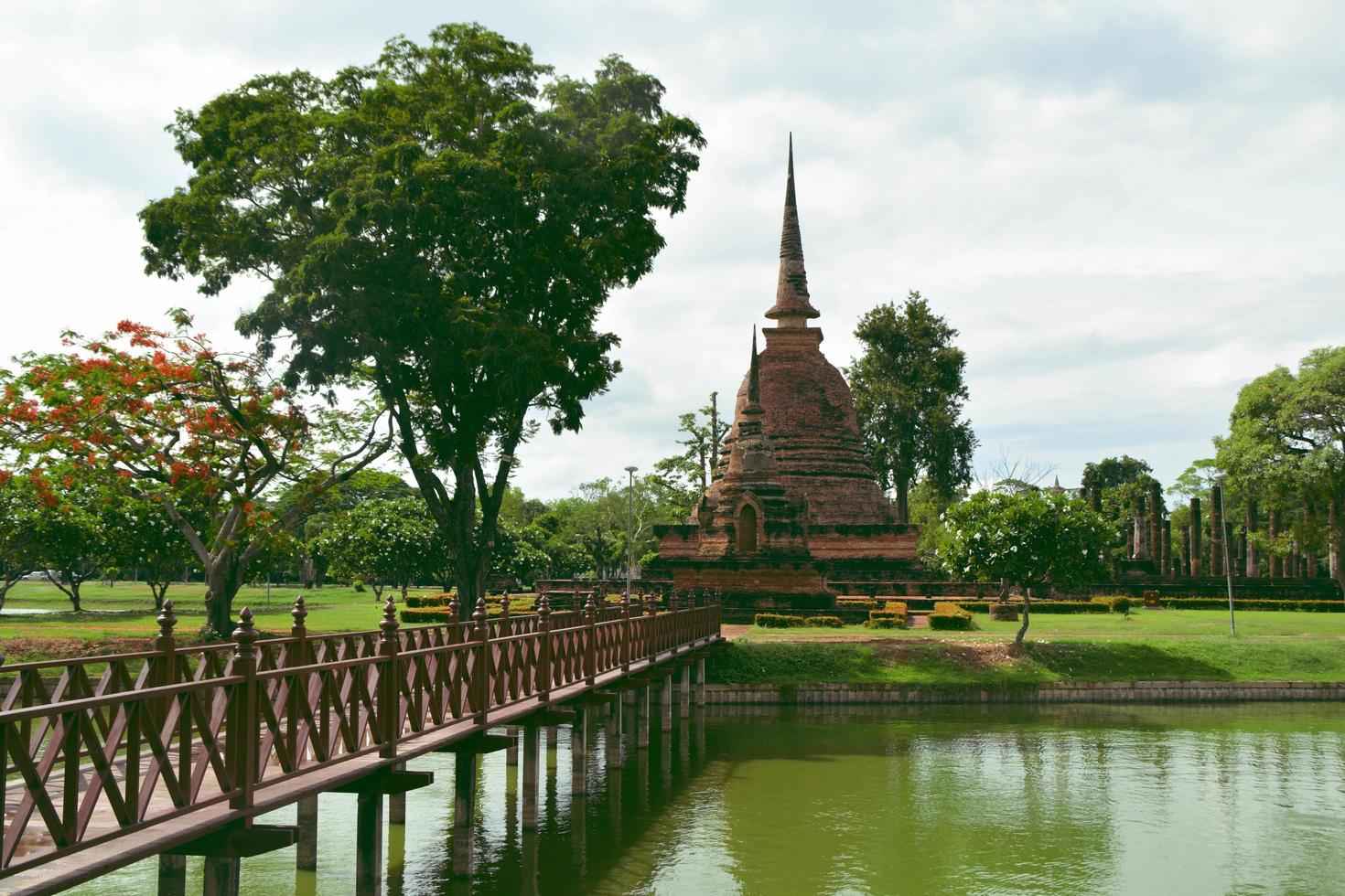 The wood bridge way to Main laterite Pagoda at the Historical Park in Sukhothai. photo