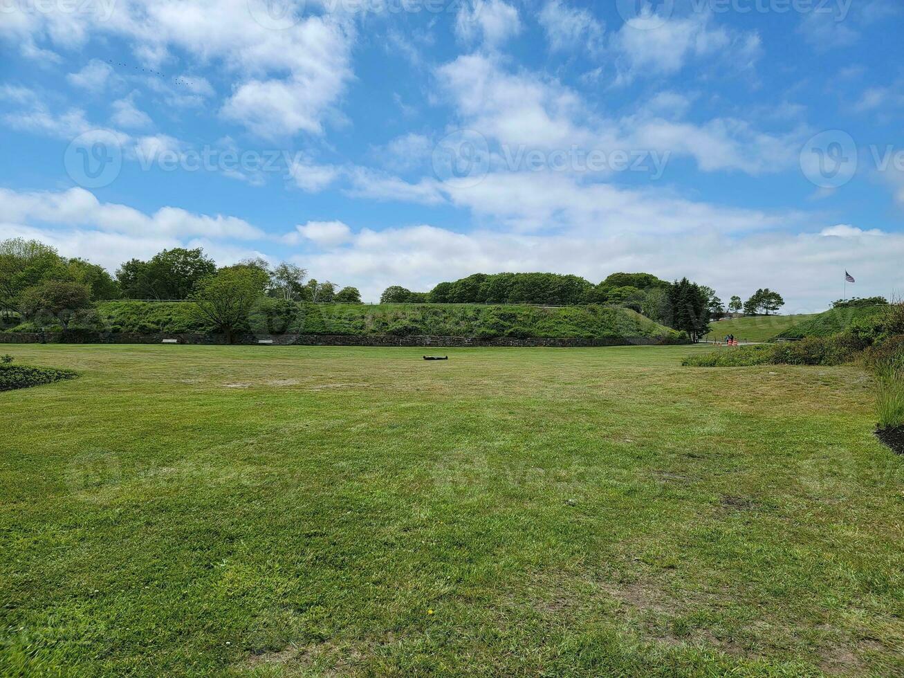 man laying down or sleeping in green grassy field photo