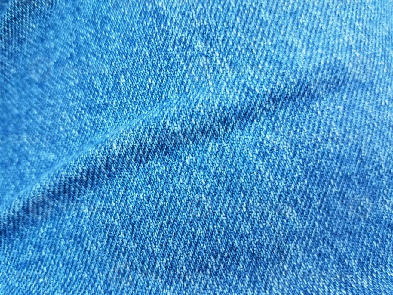 blue denim jean fabric or textile with a crease photo