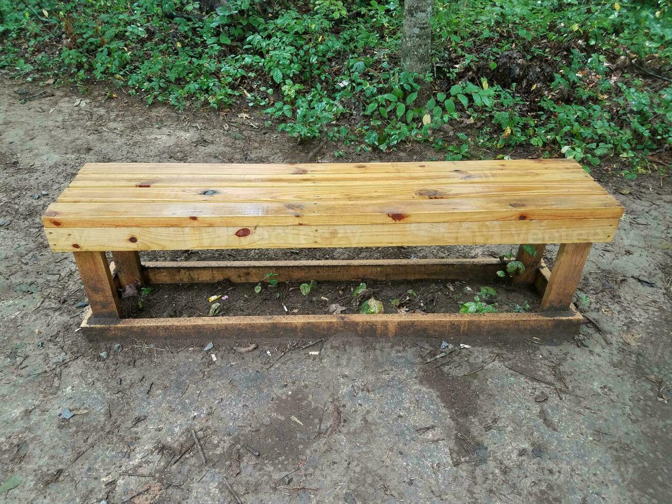wood bench on the ground photo