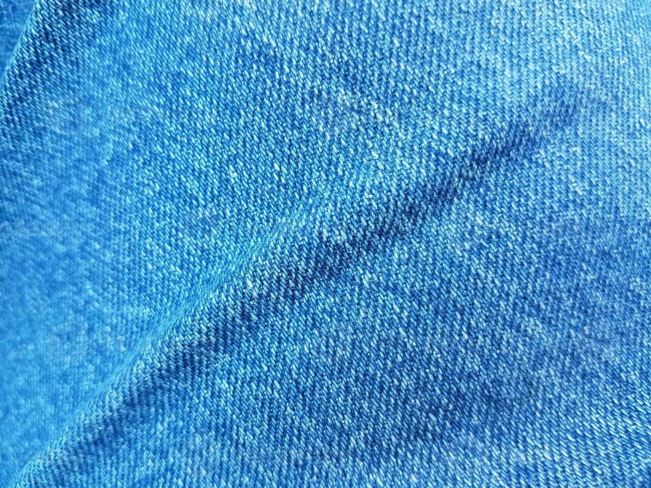 blue denim jean fabric or textile with a crease photo