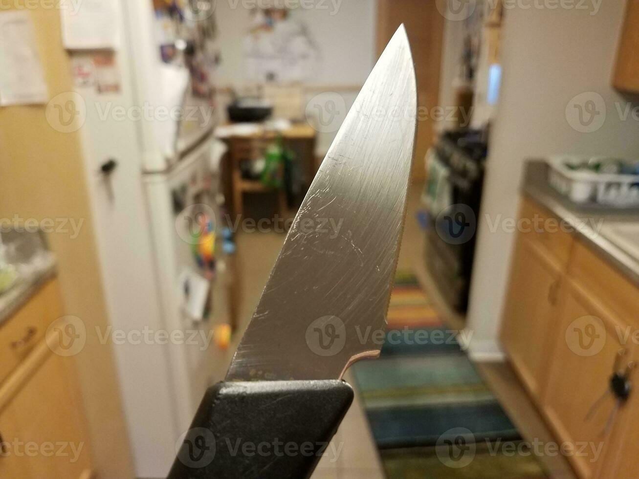sharp metal knife in kitchen first person perspective photo