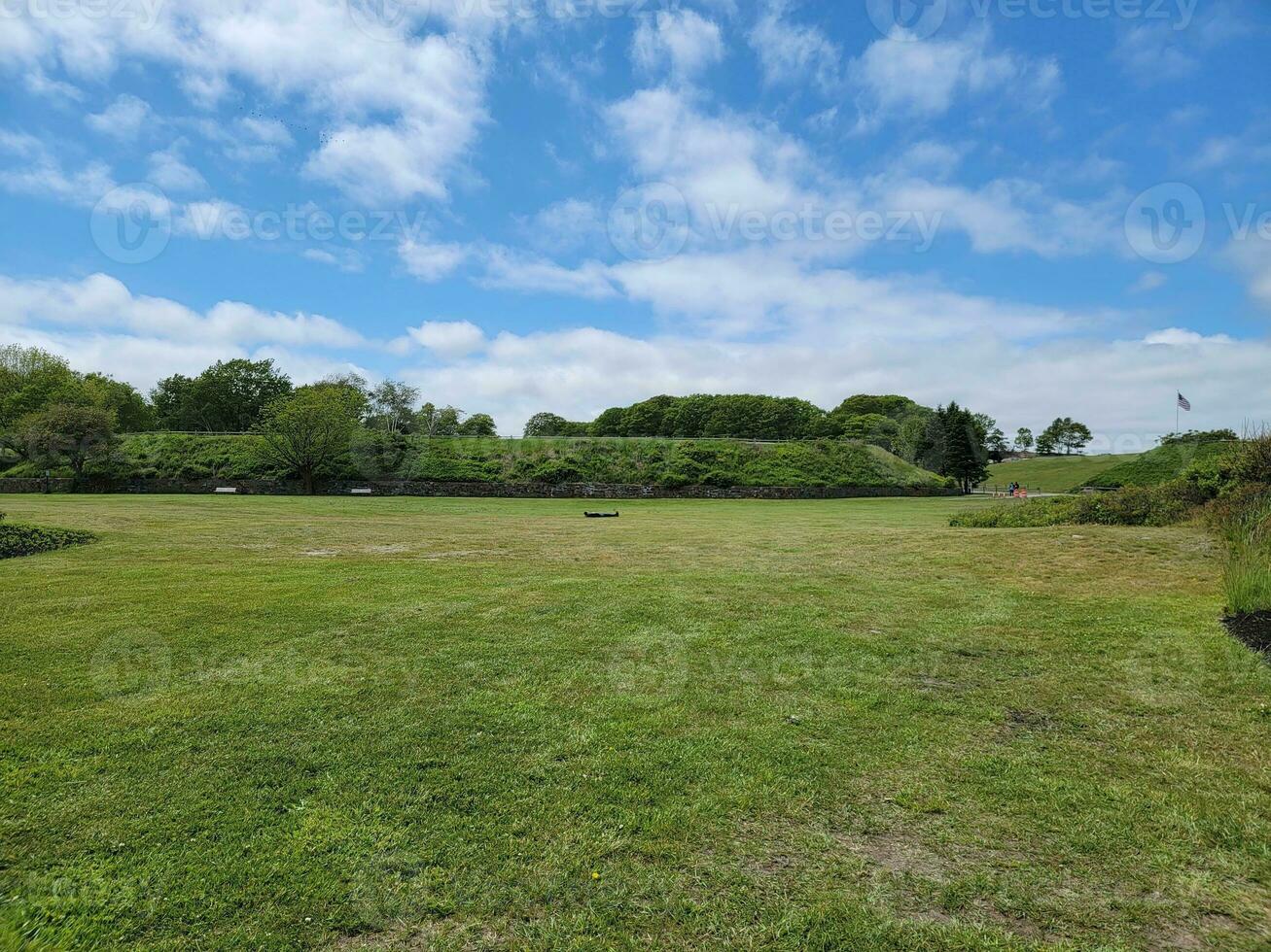 man laying down or sleeping in green grassy field photo