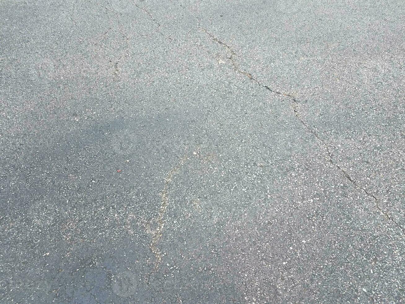 black asphalt or pavement or ground with crack photo