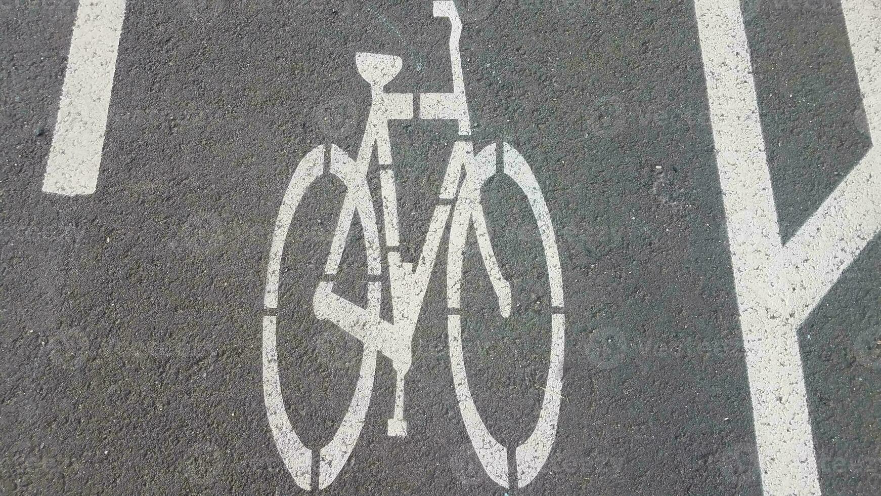 bike lane markings on black asphalt or road photo